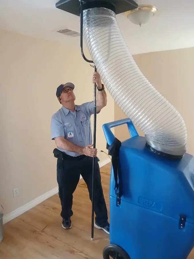 Furnace Tune-Up technician using HEPA equipment in Austell